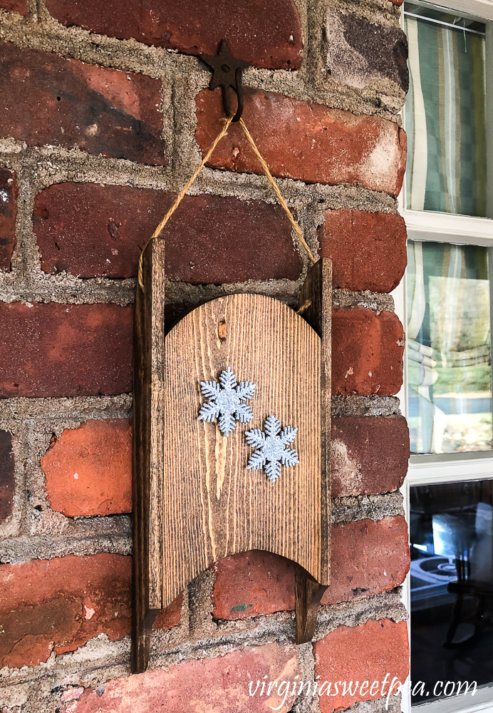 Wood sled made in the 1980s refinished and decorated with snowflakes.