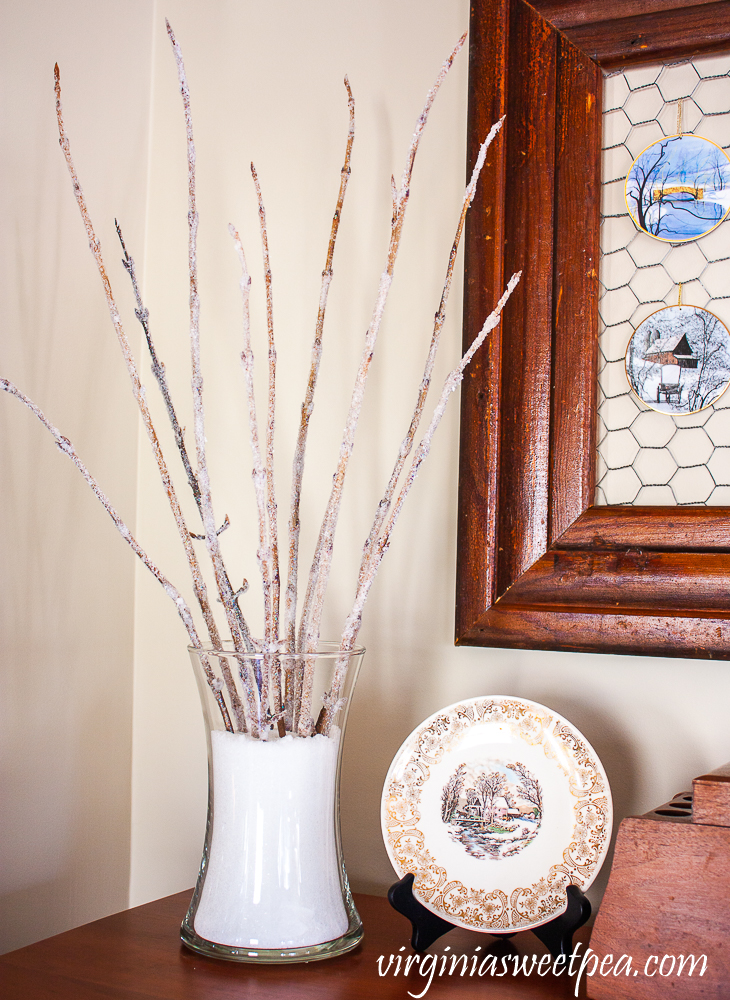 Branches with epsom salt glued to them displayed in epsom salt