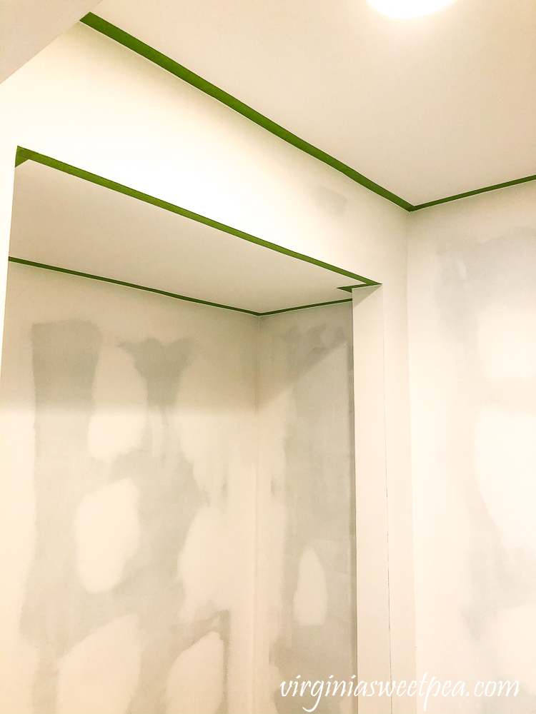 Ceiling taped with Frog Tape in preparation for painting walls