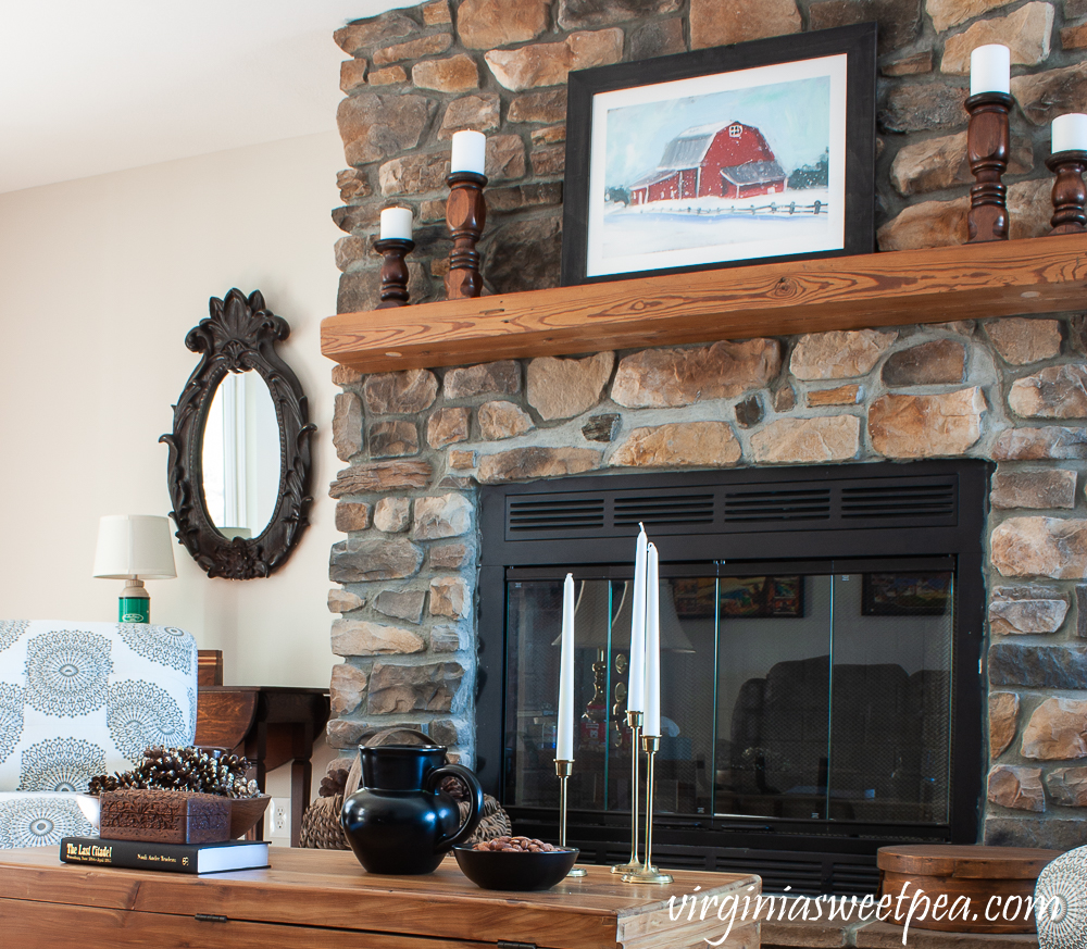 Rock fireplace and coffee table in a cabin decorated for winter