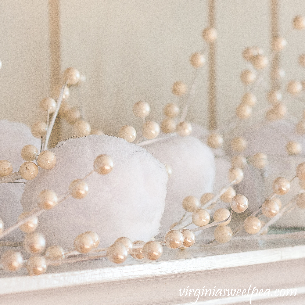 Winter mantel with snowballs, and white berries.