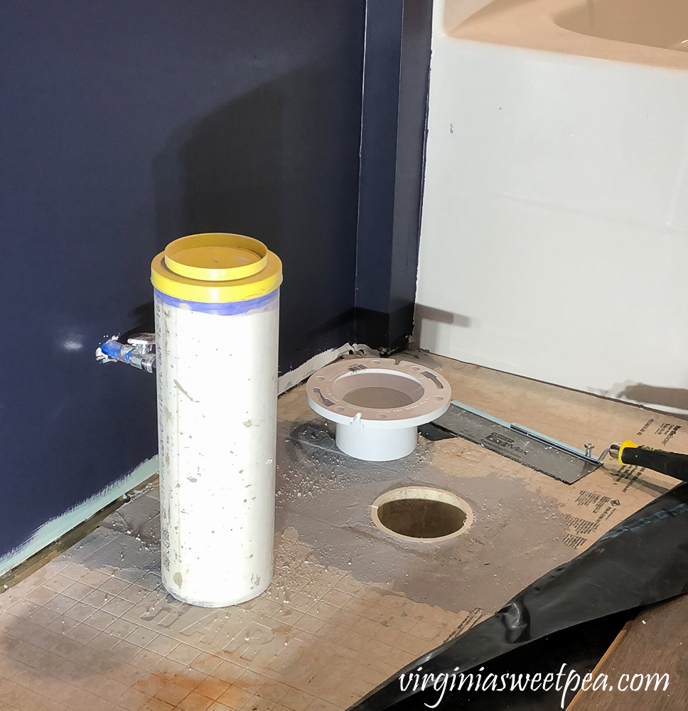 Preparing a toilet flange for flooring.