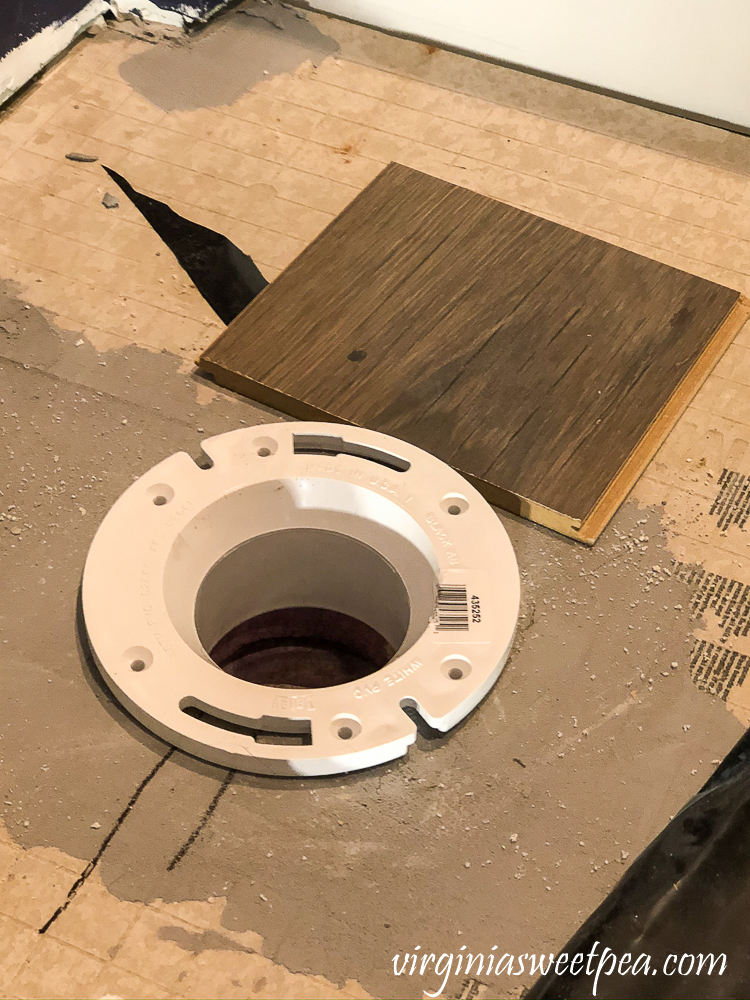 Preparing a toilet flange for flooring.