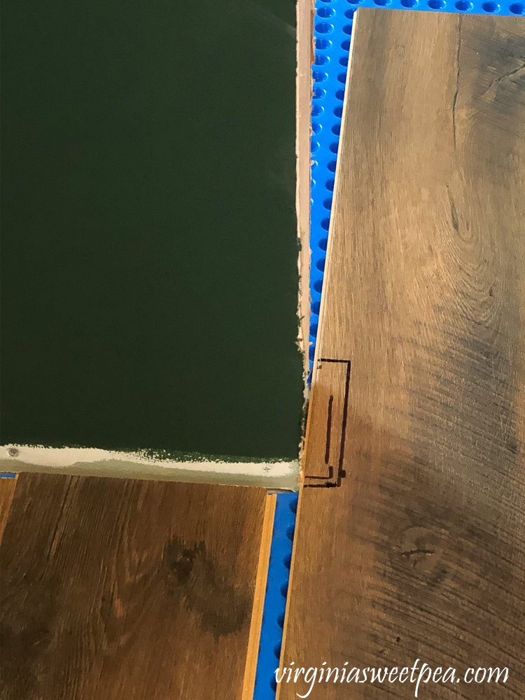 How to cut a vinyl floor plank around a door opening.