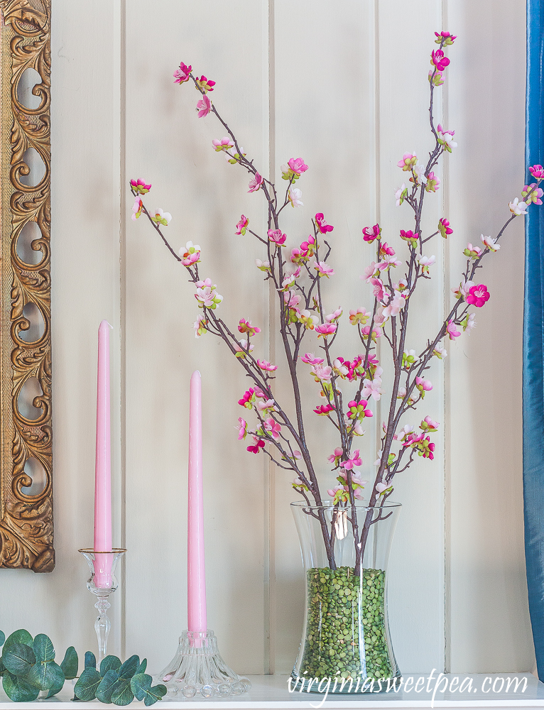 Mantel decorated for spring with pink and green