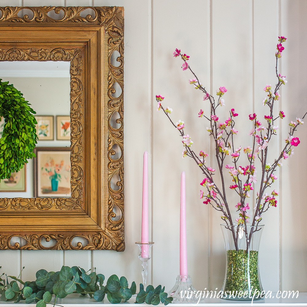 Mantel decorated for spring with pink and green