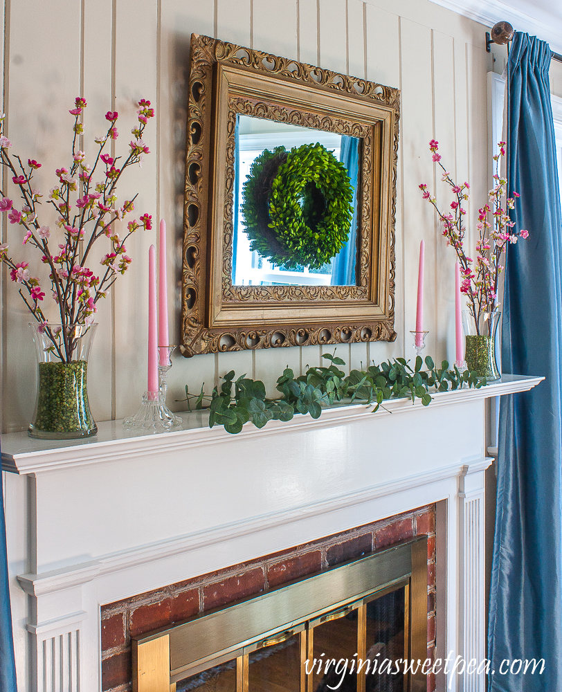 Mantel decorated for spring with pink and green