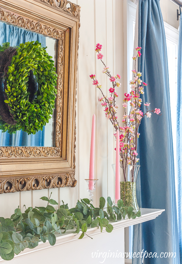 Mantel decorated for spring with pink and green