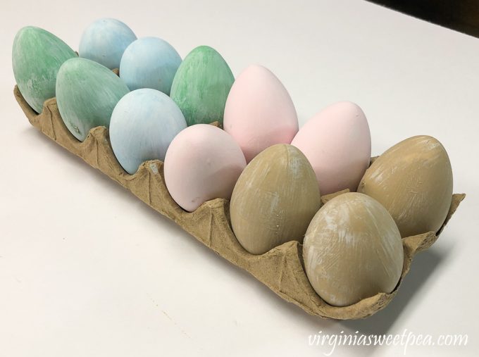 Eggs painted green, blue, pink, brown with a white wash