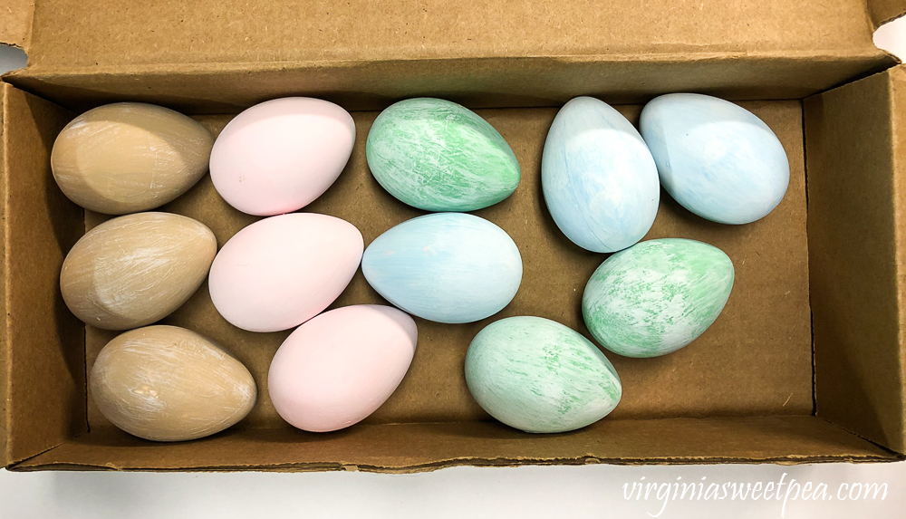 Eggs painted green, blue, pink, brown with a white wash