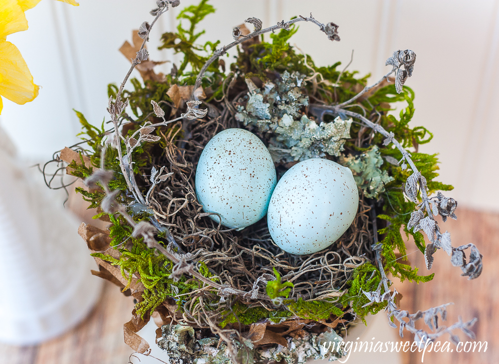 Spring nest made with a paper bag and embellished with moss, twigs, and lichen.