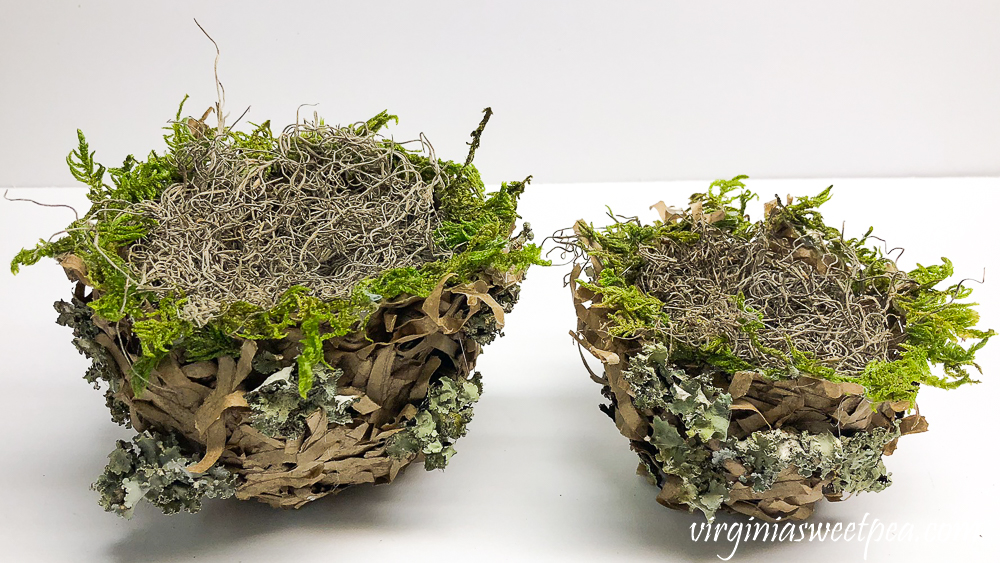 Spring nest made with a paper bag and embellished with moss, twigs, and lichen.