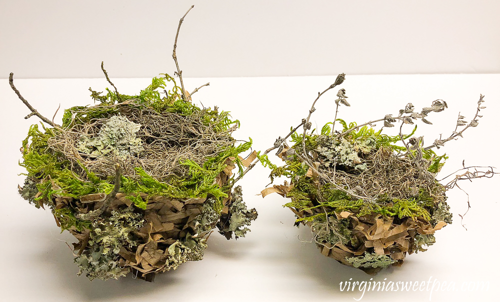 Spring nest made with a paper bag and embellished with moss, twigs, and lichen.