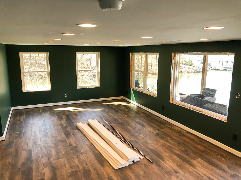 Basement with walls Painted with Sherwin Williams Emerald Paint in Rock Garden and floor installation with Mohawk Crest Loft in Prairie Oak