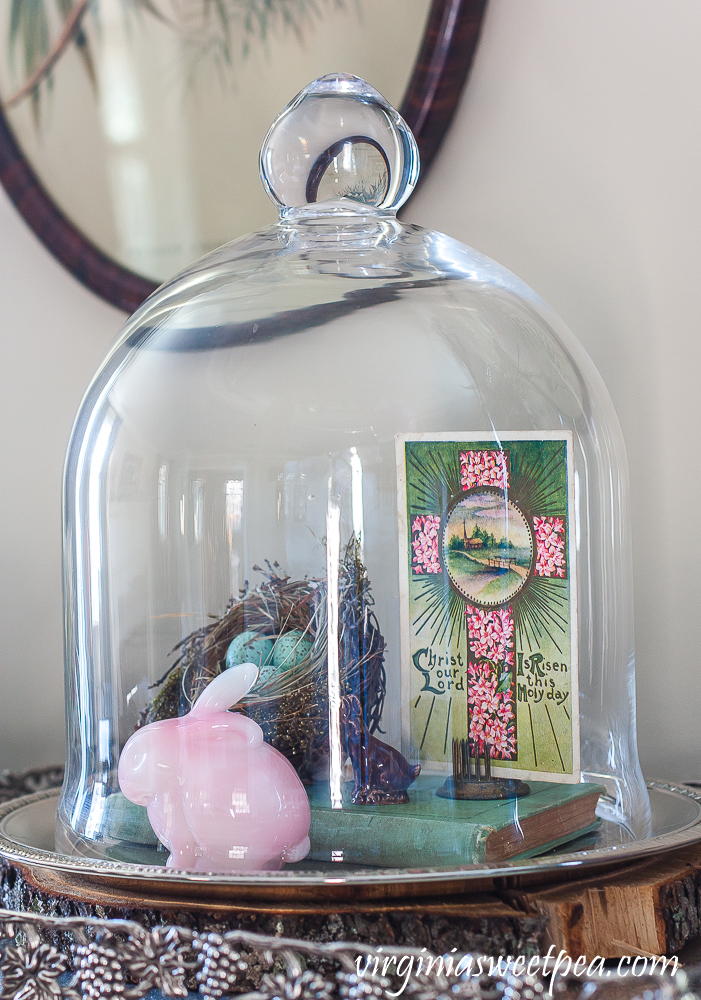 Spring Vignette with a cloche with nest, fenton rabbit and postcard