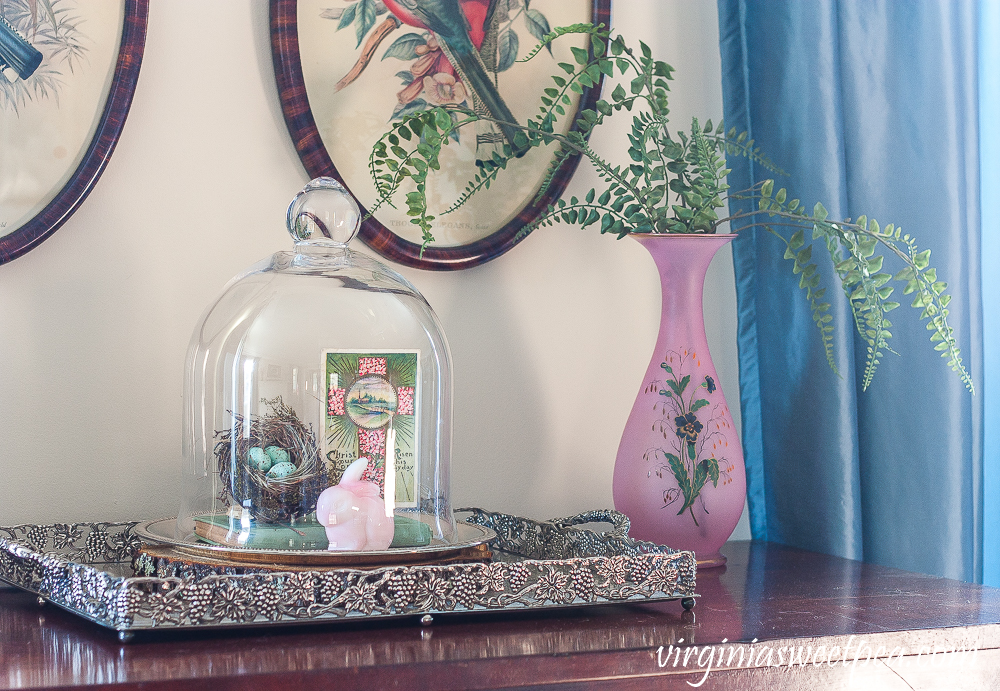 Spring Vignette with a cloche with nest, fenton rabbit and postcard, pink vase with faux ferns