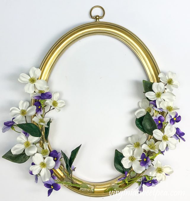 Faux dogwood and viola on a picture frame
