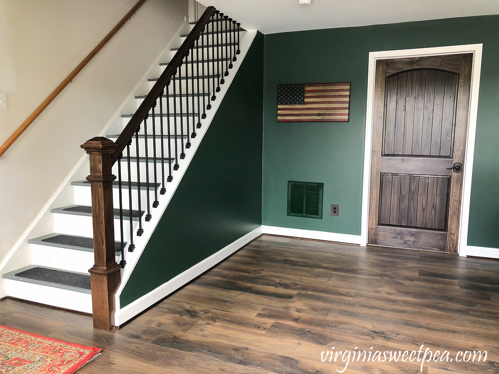 Staircase with metal balusters and a handmade wood American flag