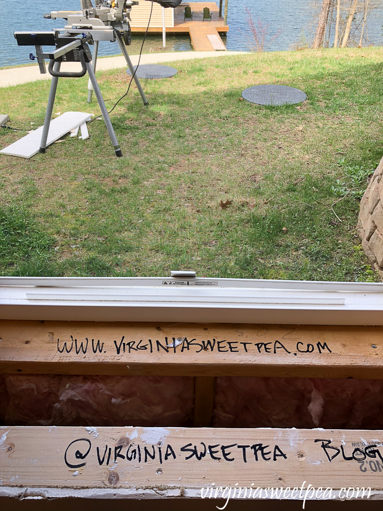 Labeling raw wood on window with virginiasweetpea.com before framing it.