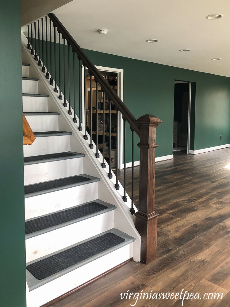 Staircase with metal balusters and wood banister and newel post.