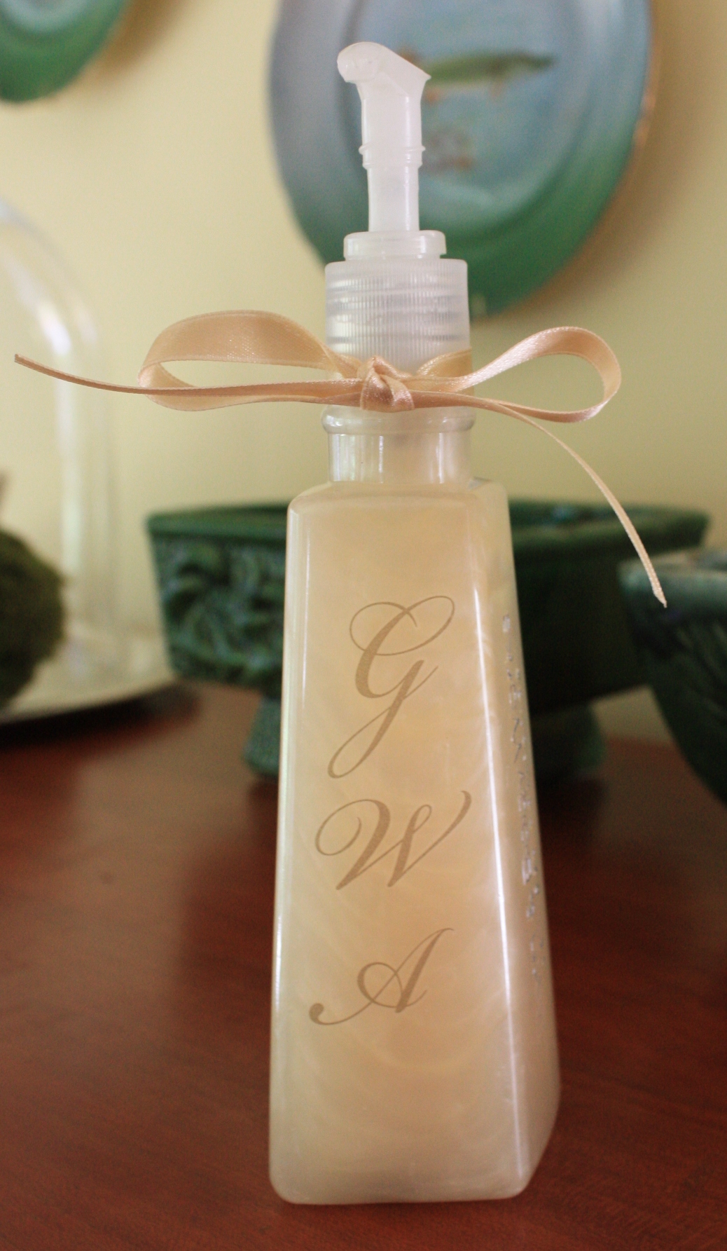 Repurposed Soap Container embellished with rub-on initials and a ribbon