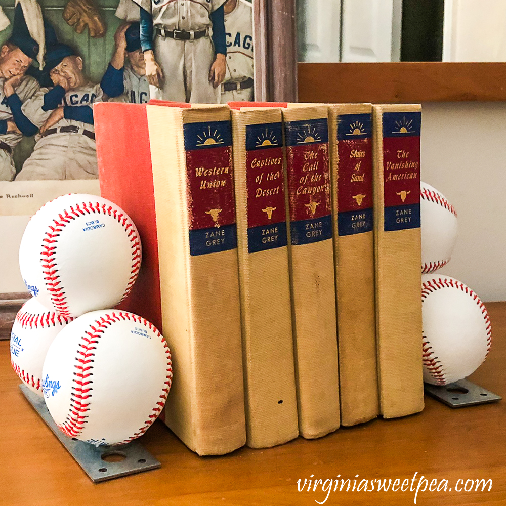 Bookends made with baseballs holding a collection of Zane Grey books