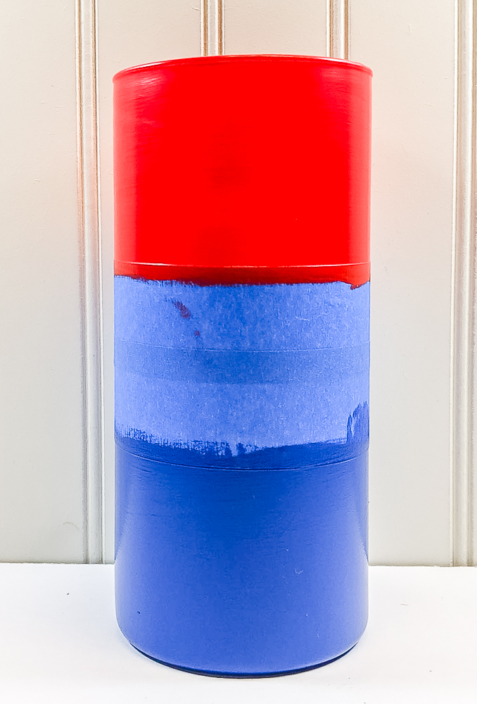 Vase painted red at the top and blue at the bottom with painter's tape in the middel