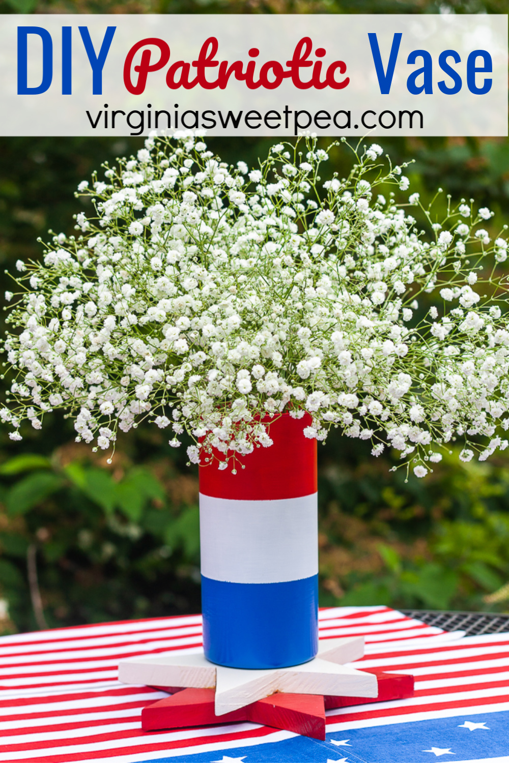 Red, white, and blue striped vase filled with Baby's Breath.