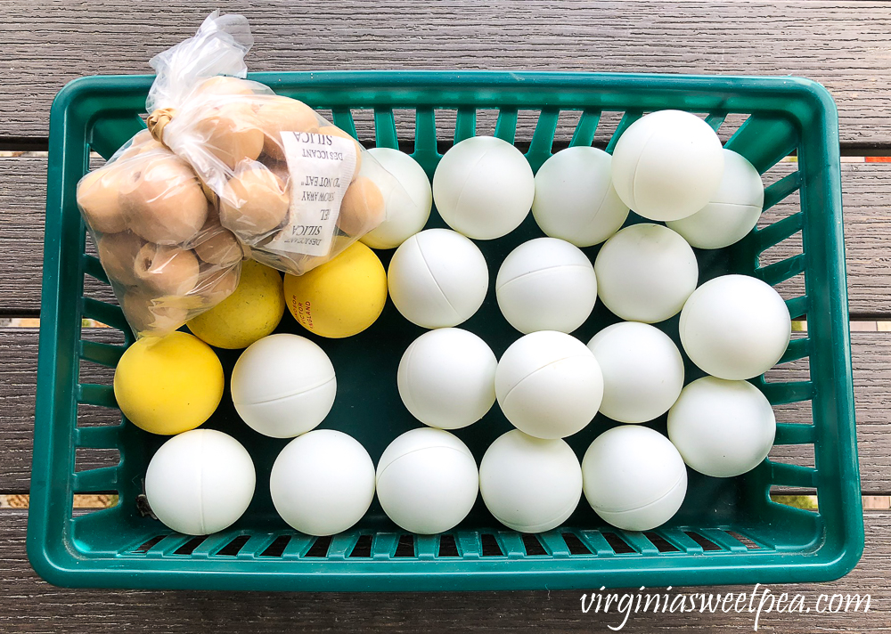 ping pongs in a green basket