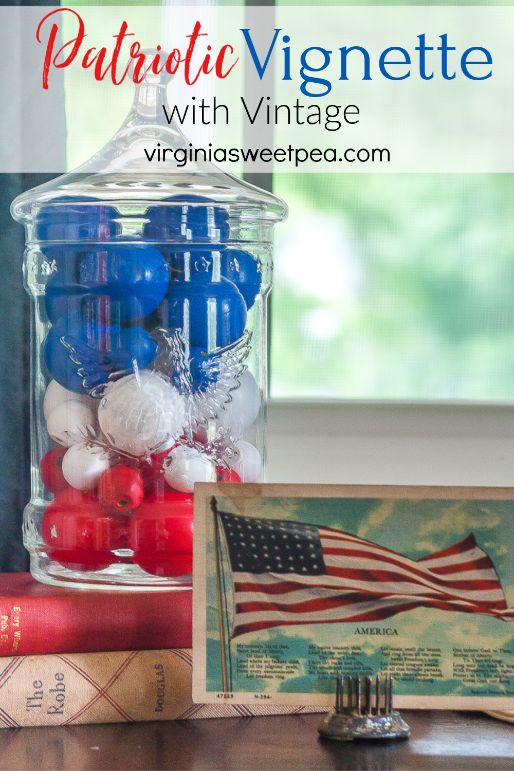 Patriotic Vignette with 1976 eagle jar with red, white, amd blue filler, American flag postcard, and glass insulator on a red candle stand on top of a vintage towel