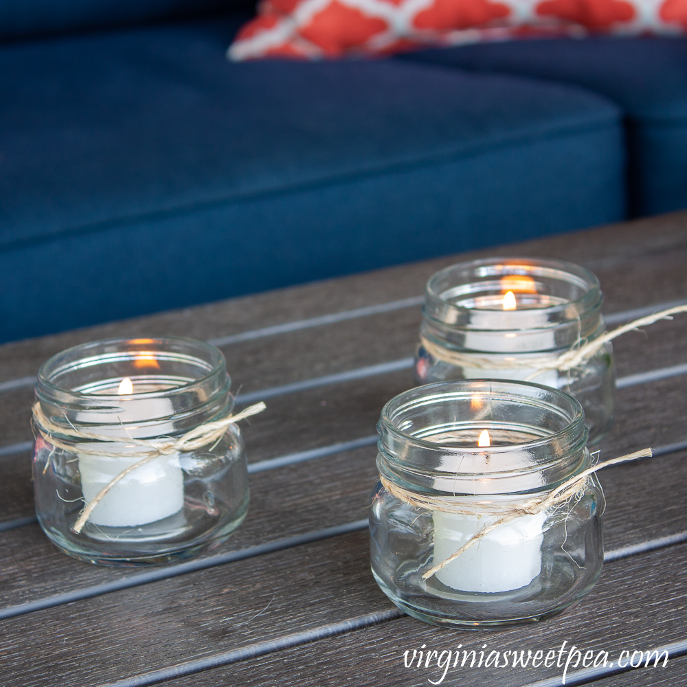 Citronella candles in Mason jars with twine tied around the rim