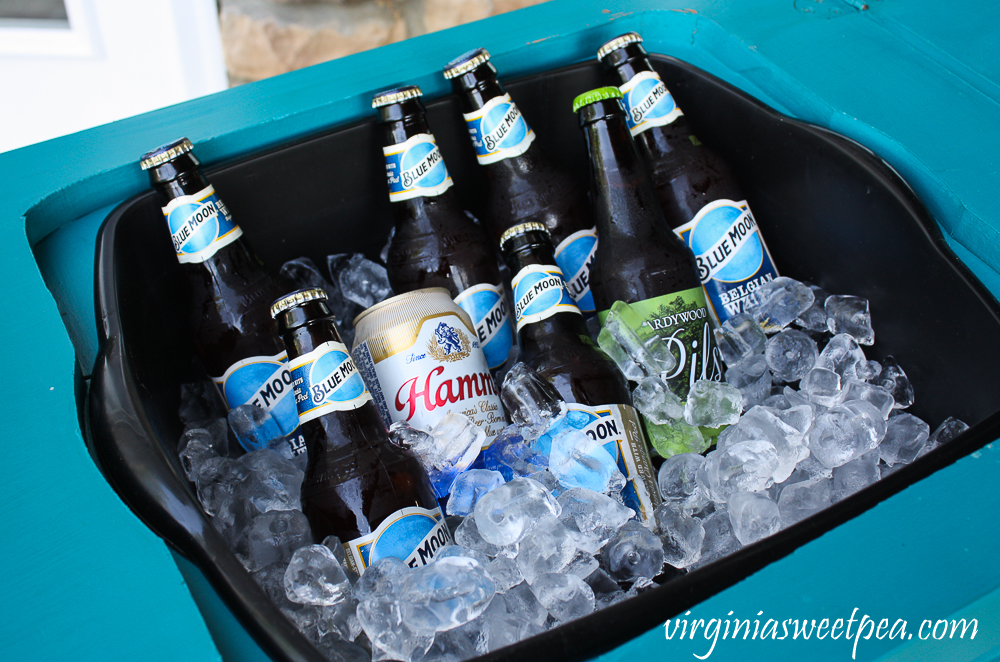 Iced down beer in a bar made from an old sewing table.