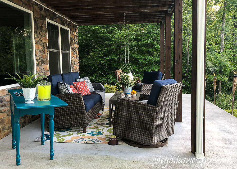 Lake house patio with furniture and a sewing table upcycled into an outdoor bar