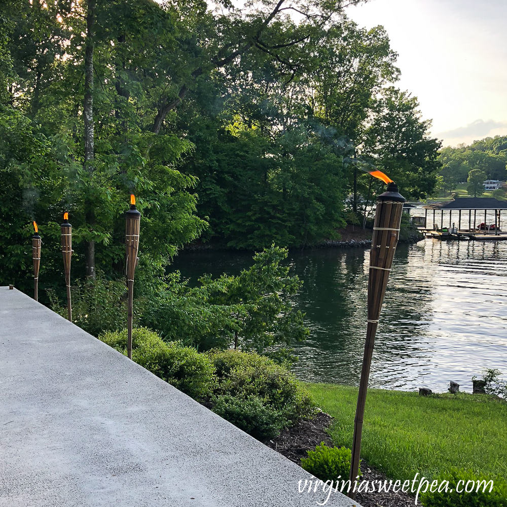 Tiki torches lit besides a patio on Smith Mountain Lake