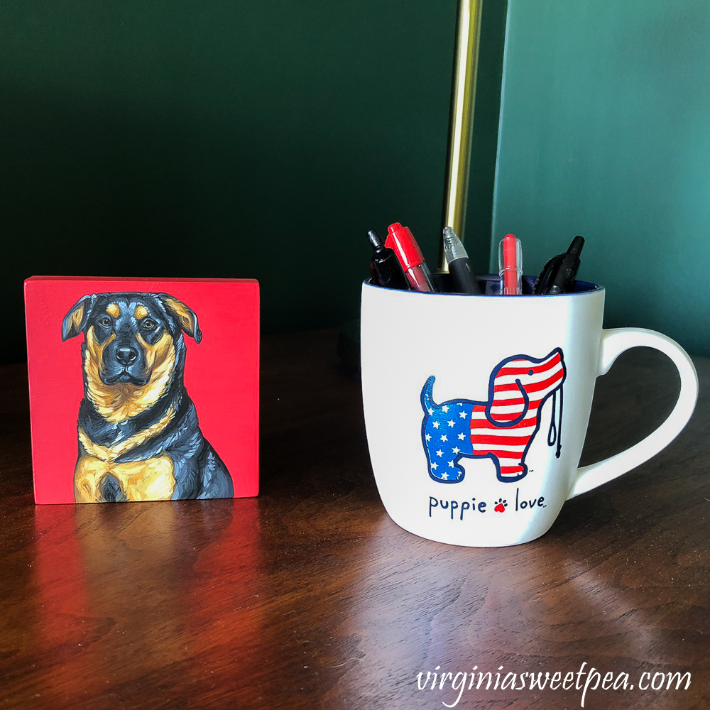 Oil painting of Sherman Skulina with a Puppy Love Mug filled with Pens