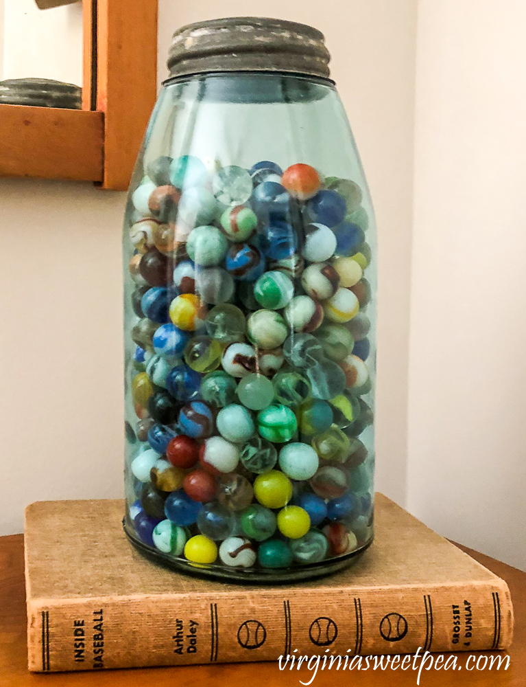 Vintage marbles in an antique blue Mason jar.