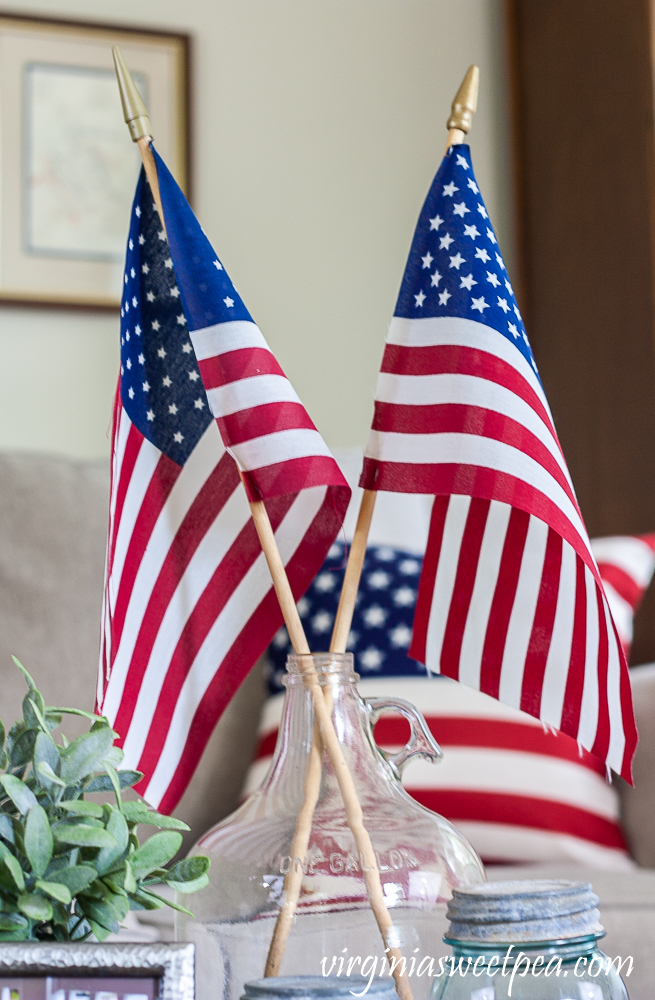 American flags in a vintage clear glass jug