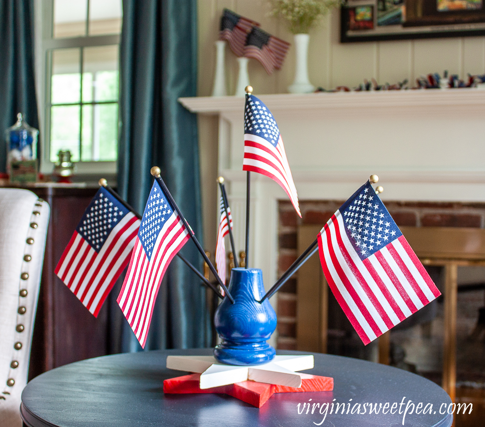 Flag Display holding six American flags with a two wooden star base.