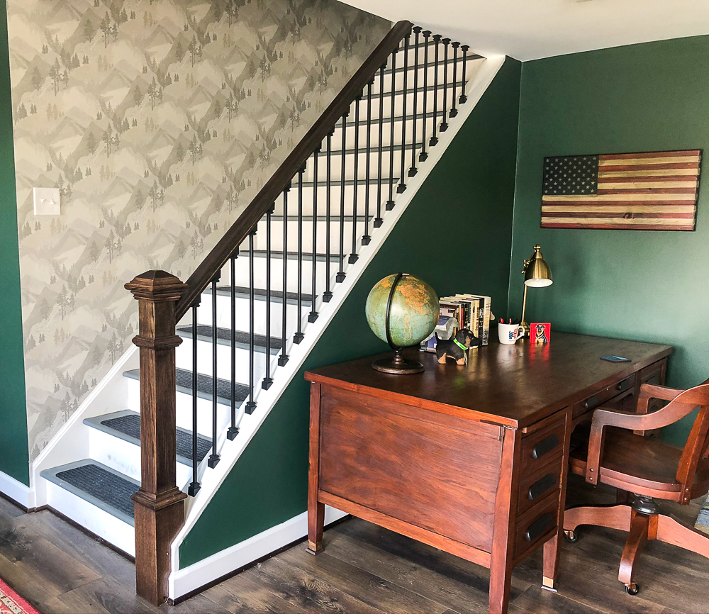 Wallpaper with a mountain and forest theme in a stairwell