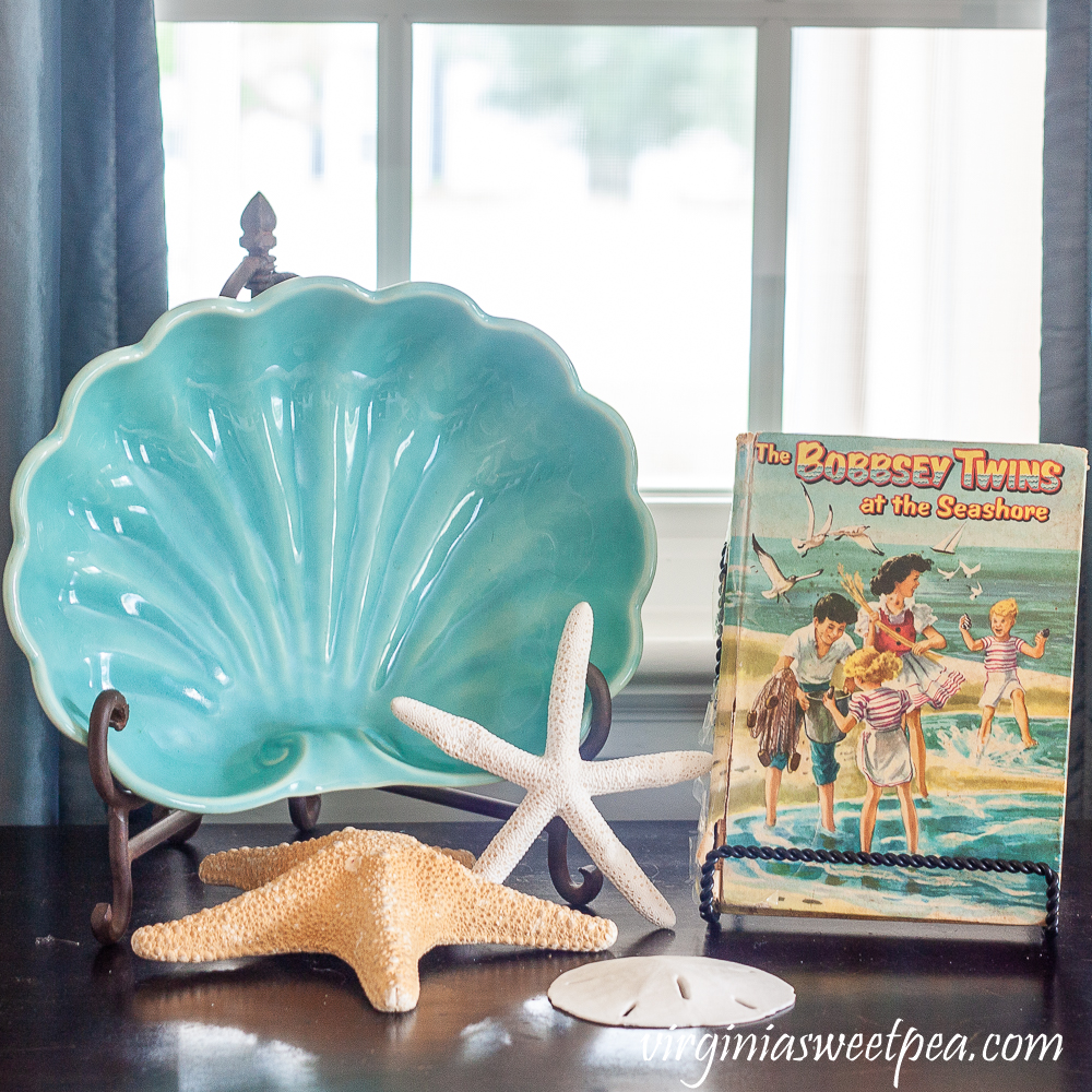 The Bobbsey Twins at the Seashore with a vintage shell shaped bowl, starfish, and sand dollar.