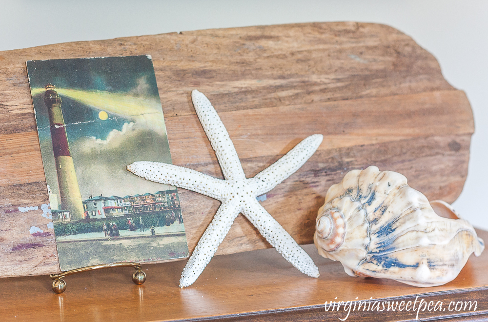 Vintage lighthouse postcard, starfish, and shell