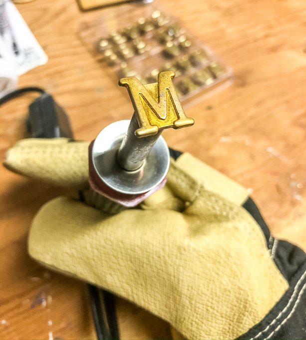 Attaching the letter M to a wood burning tool kit.