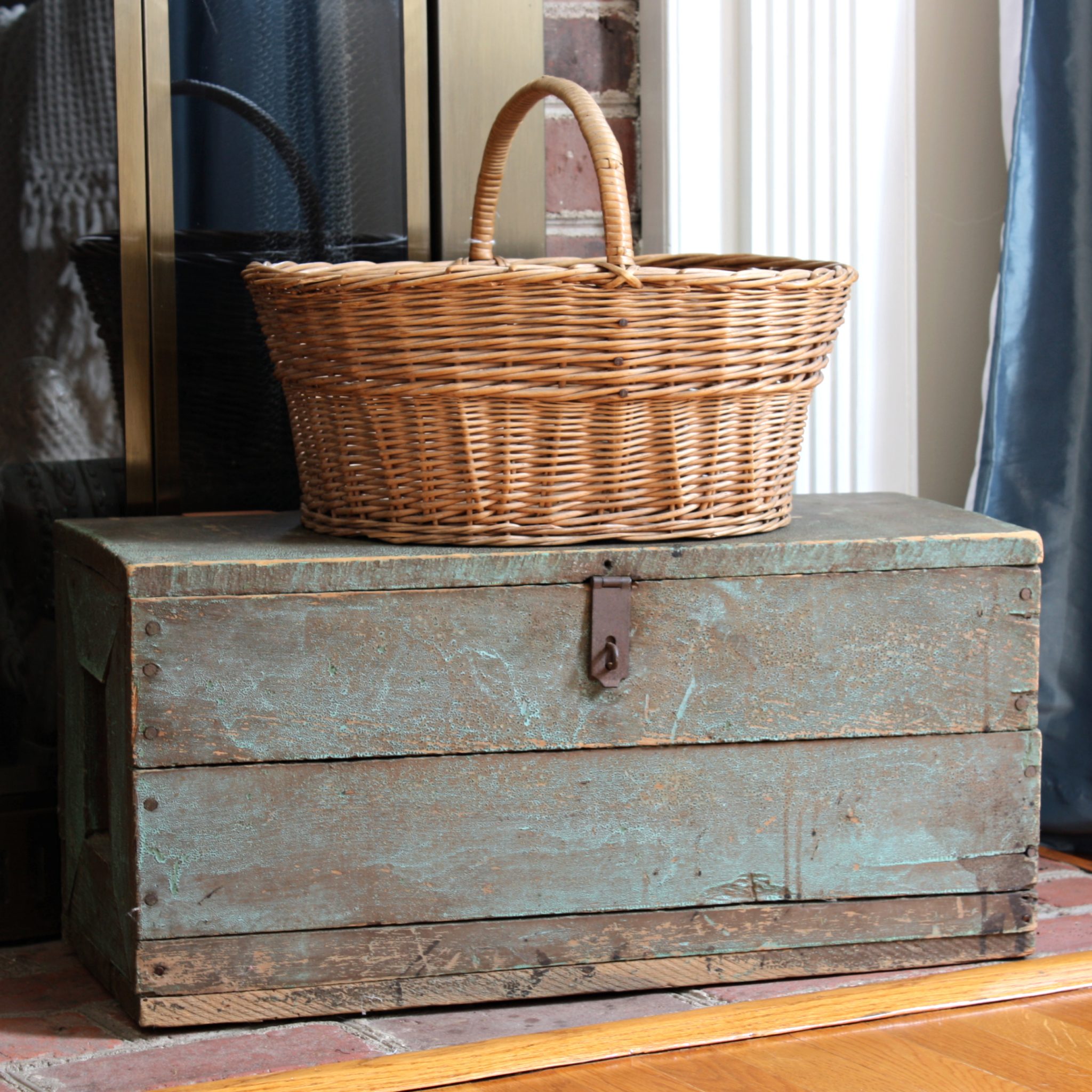 Vintage toolbox with a vintage basket on top of it.