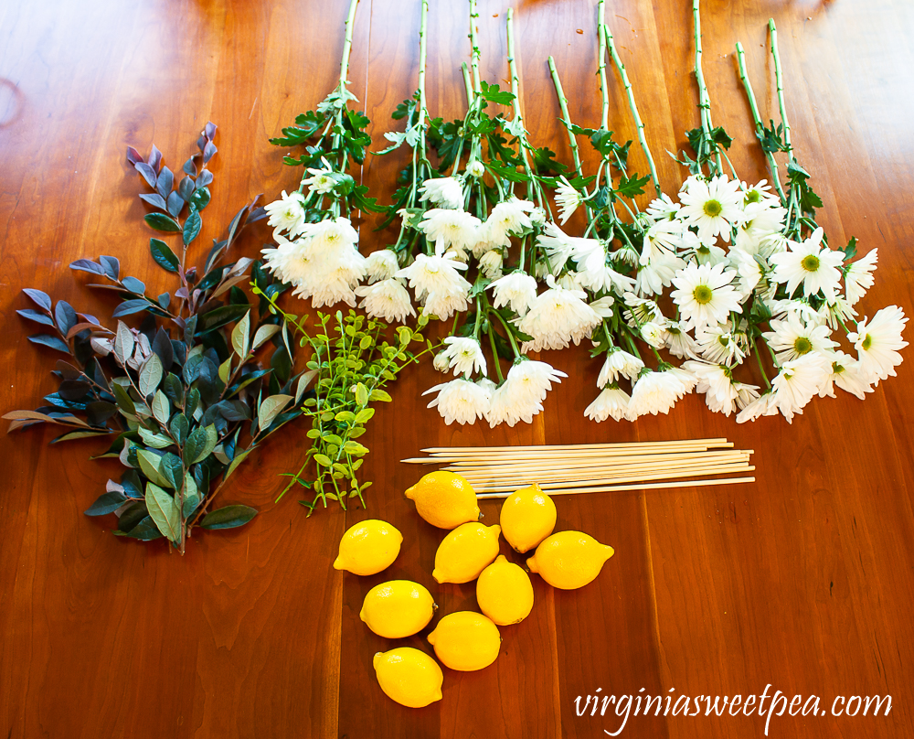 Flowers and fruit cut and prepped for making a flower arrangement