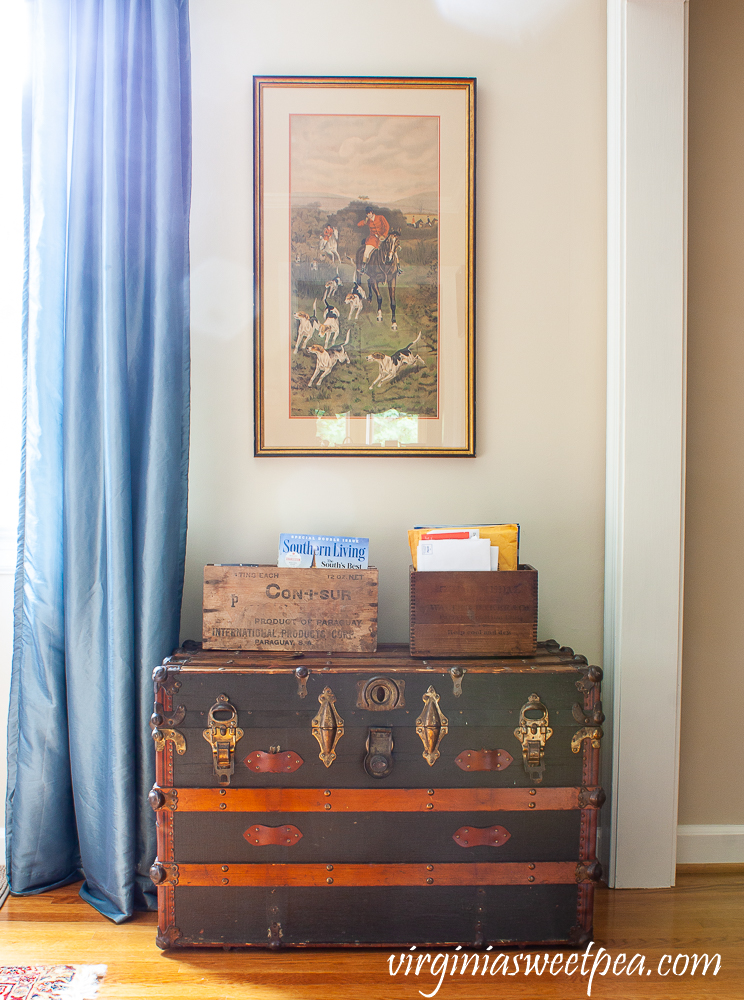 Vintage trunk with two crates used to organize mail.