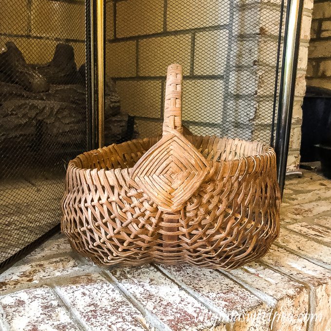 Vintage basket on fireplace hearth