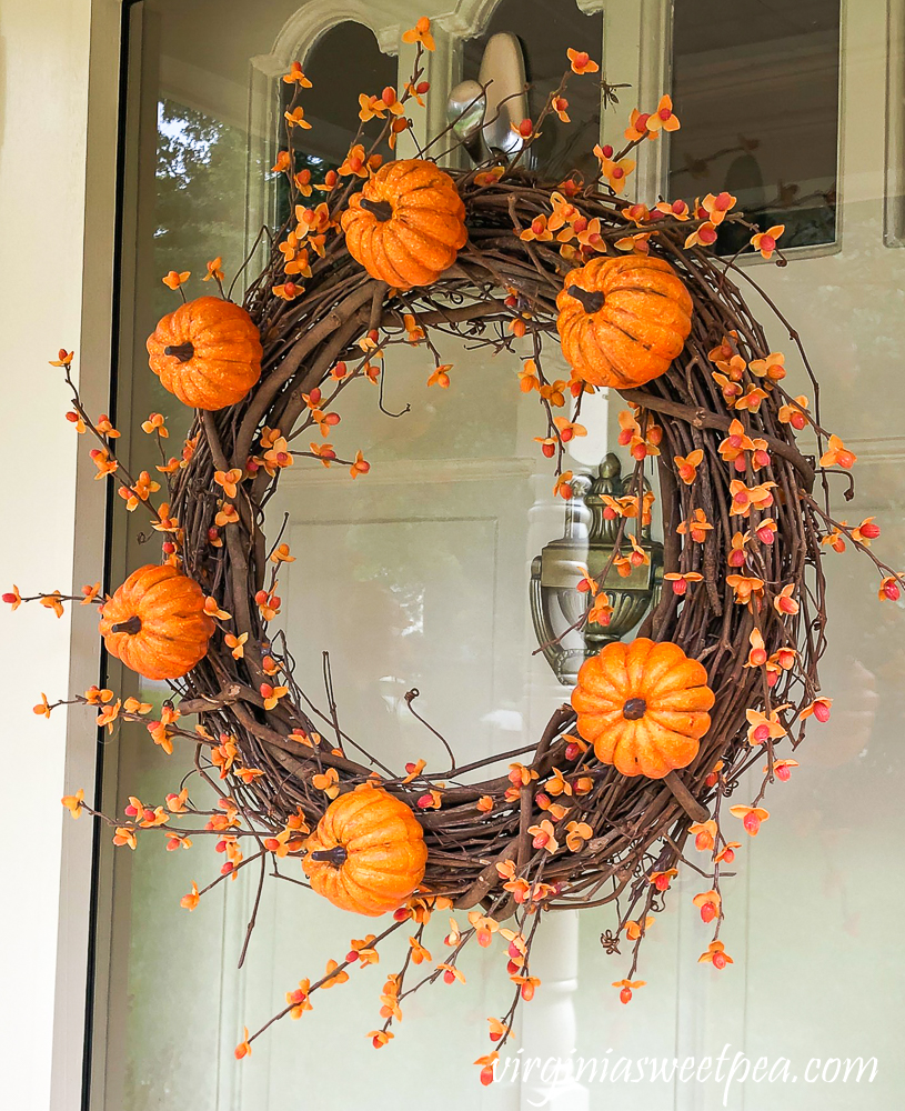 Grapevine wreath for fall with pumpkins and bittersweet