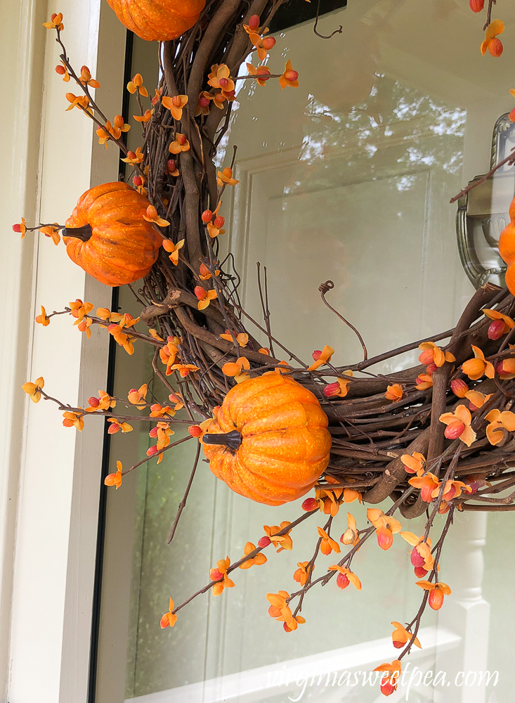 Pumpkin picks and faux bittersweet on a grapevine wreath