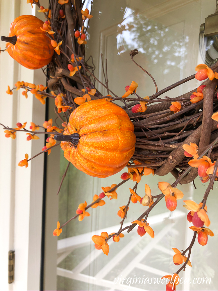 Pumpkin picks and faux bittersweet on a grapevine wreath