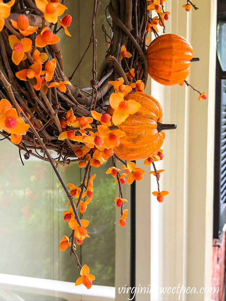 Pumpkin picks and faux bittersweet on a grapevine wreath